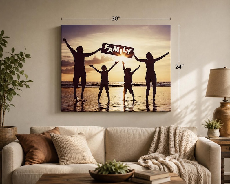 May include: A rectangular wall canvas print measuring 30 inches by 24 inches, featuring a silhouette of a family of four standing on a beach at sunset. The two adults and two children have their arms raised, holding a sign that reads FAMILY.