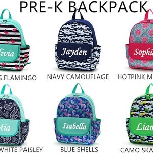 May include: Six different pre-k backpacks with various colorful patterns and personalized names. The backpacks are made of a soft, water-resistant material and feature a zippered closure, adjustable straps, and a front pocket. The patterns include stripes with flamingos, navy camouflage, hot pink medallions, navy and white paisley, blue shells, and camo skateboard.