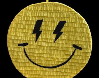 May include: A yellow smiley face pinata with black lightning bolt eyes and a black smile.