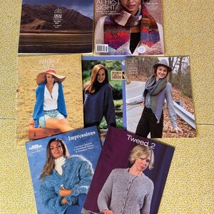 May include: A collection of seven knitting pattern magazines featuring various designs, including Amano, Noro, Shibui Silk, Manos del Uruguay, CEY, Rowan, and Tweed 2, displayed with colorful photography of garments and accessories on the covers.
