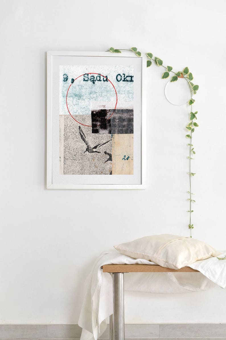 May include: A framed abstract collage with a red circle, black and white shapes, and a bird in flight. The text "Sadu Okr" is visible in the top right corner of the image.