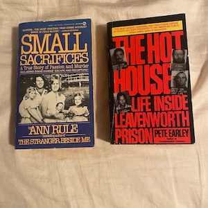 May include: Two true crime paperback books. The book on the left is titled "Small Sacrifices: A True Story of Passion and Murder" by Ann Rule, bestselling author of "The Stranger Beside Me". The book on the right is titled "The Hot House: Life Inside Leavenworth Prison" by Pete Earley, author of "Circumstantial Evidence".