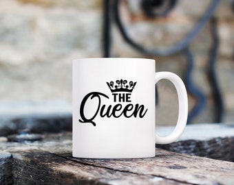 May include: White ceramic mug with a black crown and the text "THE Queen" printed on it.
