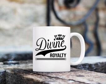 May include: White ceramic mug with a black crown and the text "Divine Royalty" printed on it.