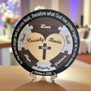 May include: A circular wooden puzzle with a heart-shaped central design, inscribed with the names "Cassidy" and "Kevin" and a cross. The puzzle includes the words "Love", "Trust", "Hope", "Loyalty", "Patience", and "Faith". The date "October 4, 2025" is also displayed.