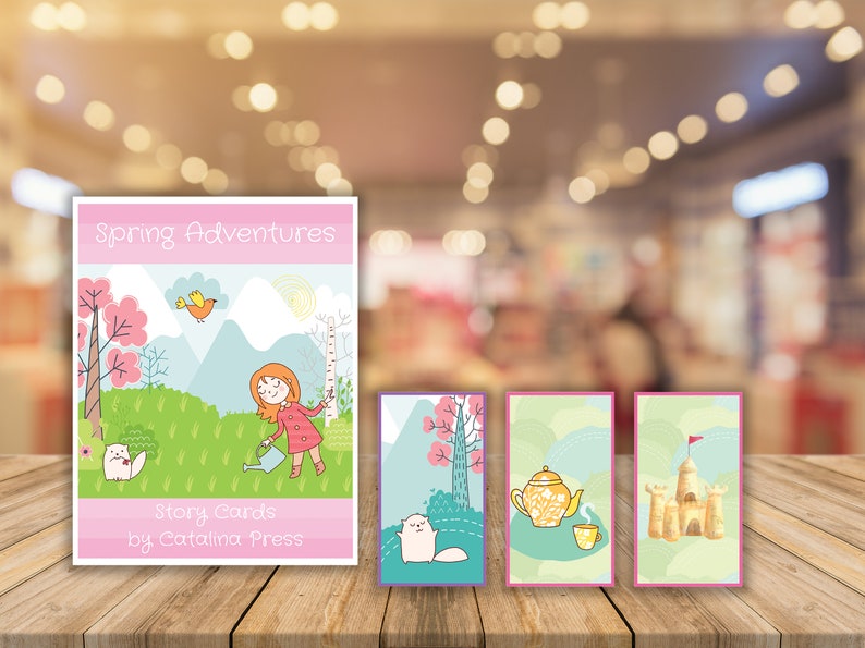 May include: A set of spring-themed story cards featuring a girl watering a tree, a cat, a teapot and a teacup, and a sandcastle. The cards are pink, green, and blue with a white background. The title card reads "Spring Adventures Story Cards by Catalina Press".