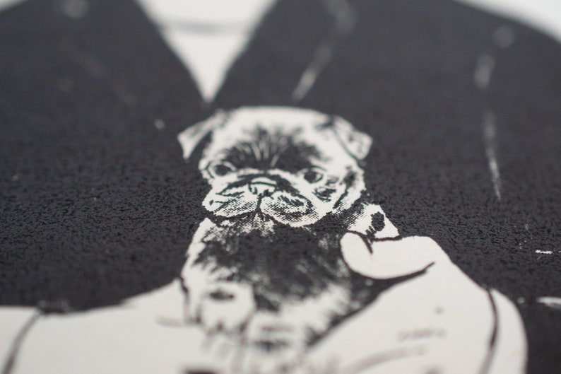 May include: A monochrome graphic featuring a pug dog. The image is a close-up, highlighting the dog's face and expression. The pug is rendered with detailed shading and a textured effect. The background is a dark, textured surface.