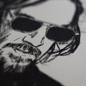 May include: Close-up black and white sketch of a person's face wearing sunglasses. The sketch is detailed, with visible lines and shading, creating a textured appearance. The image is on a white background.