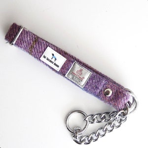 May include: Purple tweed dog collar with a silver chain and a label that reads "HAND WOVEN IN THE COTSWOLDS ENGLAND".
