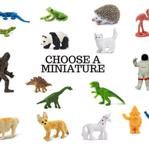 May include: A collection of miniature figurines, including a green dinosaur, a blue lizard, a panda, a white cat, a pink flamingo, a brown hedgehog, a green frog, a brown yeti, a green dinosaur, a green dinosaur, a white astronaut, a llama, a fennec fox, a unicorn, a yellow gnome, and a blue gnome. The text "Choose a Miniature" is displayed in the center of the image.
