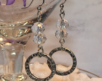 Silver ring and crystal dangle earrings; antique silver hammered ring dangling beneath two crystals