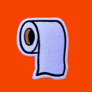 May include: A white embroidered patch of a toilet paper roll with a black outline. The roll is partially unrolled and has a brown center.