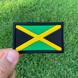 May include: A black, green, and yellow embroidered patch featuring the Jamaican flag.