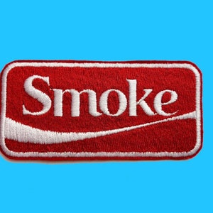 May include: Red and white embroidered patch with the word "Smoke" in white lettering.