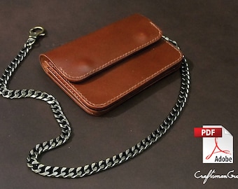May include: A brown leather wallet with a chain attached. The wallet has a fold-over flap and a silver clasp. The chain is silver and has a black finish.