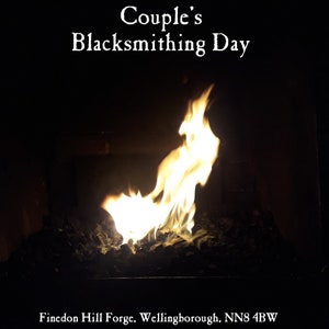 May include: A close-up of a blacksmith's forge with flames burning brightly. The forge is labelled "Couple's Blacksmithing Day" and "Findon Hill Forge, Wellingborough, NN8 4BW".