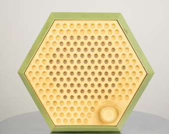 May include: A hexagonal shaped vintage radio with a green outer shell and a yellow speaker grill. The speaker grill has a pattern of small circles.