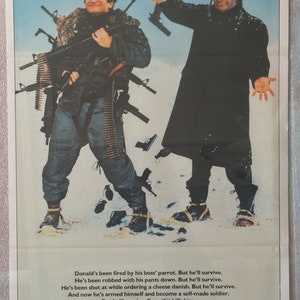 May include: A movie poster for the film "The Survivors" starring Walter Matthau and Robin Williams. The poster features a humorous image of the two actors dressed in winter gear and holding guns. The tagline reads "Once they declare war on each other, watch out. You could die laughing."