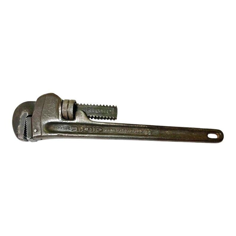 May include: A vintage RIDGID pipe wrench with a 14-inch capacity. The wrench is made of metal and has a black finish. The wrench has a handle with a textured grip and a jaw with a serrated edge.