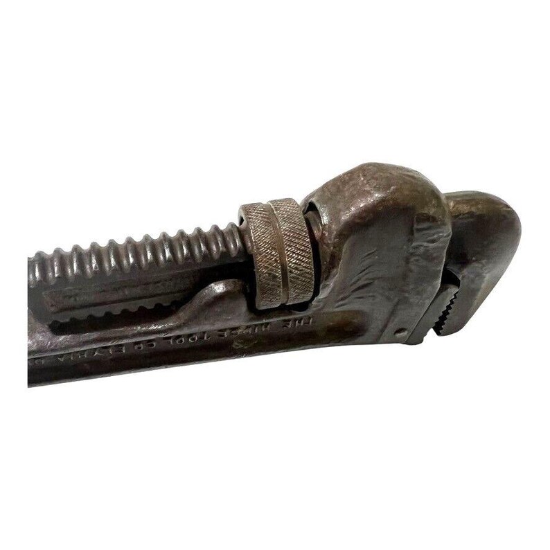 May include: A vintage, rusty, adjustable pipe wrench with a black finish and the text "THE WM.T. TOOL CO.".