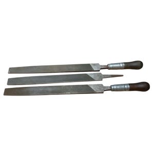 May include: Three metal files with wooden handles. The files are different lengths and have a rough, textured surface.
