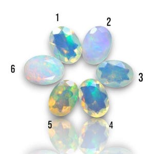 May include: Six oval-shaped opals in various shades of white, blue, and green. The opals are arranged in a circle with numbers 1 through 6 written around them.