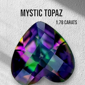 Könnte beinhalten: Ein herzförmiger Mystic Topaz Edelstein mit einem Regenbogen aus Farben, darunter Lila, Grün und Blau. Der Edelstein ist 1,78 Karat schwer.