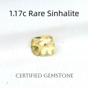 Puede incluir: Una piedra preciosa de Sinhalite amarilla de 1,17 quilates, una variedad rara de piedra preciosa. La piedra preciosa tiene forma de cojín y tiene una superficie lisa y pulida. Es una piedra preciosa certificada.