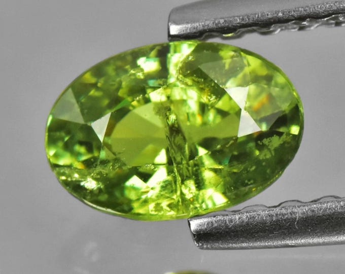 0.57 Carat Natural "Horsetail" Demantoid Garnet Faceted Oval Cut. 6.000 x 4.000 x 2.700 mm Loose Gemstones. Untreated and Earth Mined.