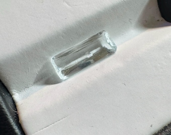 Discounted: 1.25 Carat Natural Aquamarine. Faceted Rectangle Cut Loose Gemstone for Making Pendants. Table Damage. 11.7 x 4.5 x 2.9 mm.