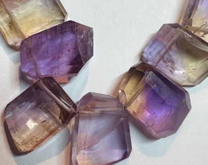 Ametrine Beads. Faceted. 4 Pieces. Natural Bi-Color Ametrine. Fancy Emerald Cut from Bolivia. 16.5 x 12 x 7.9 mm. Heated. Included Grade.