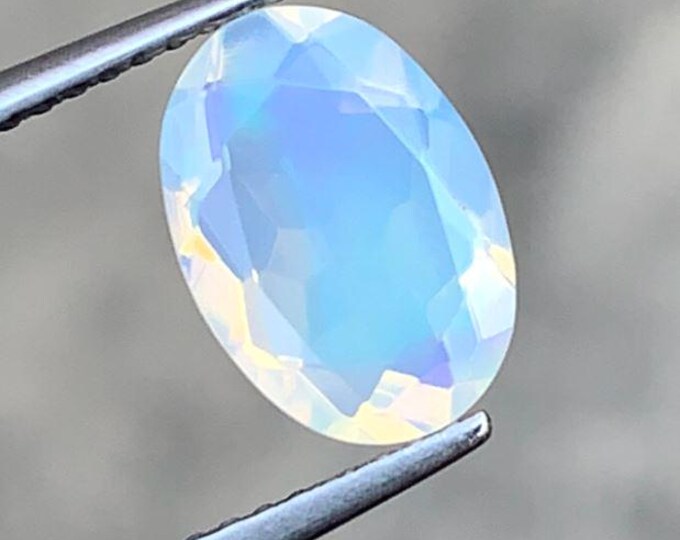 1.55 Carat Natural White Opal. Faceted Oval. 10.40 x 7.30 x 4.80 mm. Genuine Earth Mined. Untreated. Birthstone Gift. Loose Gemstones.