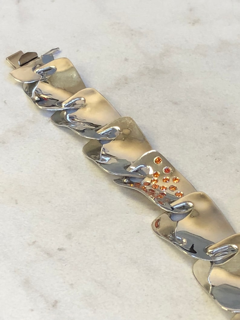 Sterling Silver Fashion Statement Bracelet with Garnet Gemstone in Center at an Incredible Price.