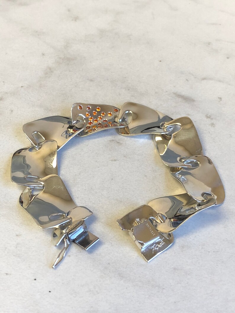 Sterling Silver Fashion Statement Bracelet with Garnet Gemstone in Center at an Incredible Price.
