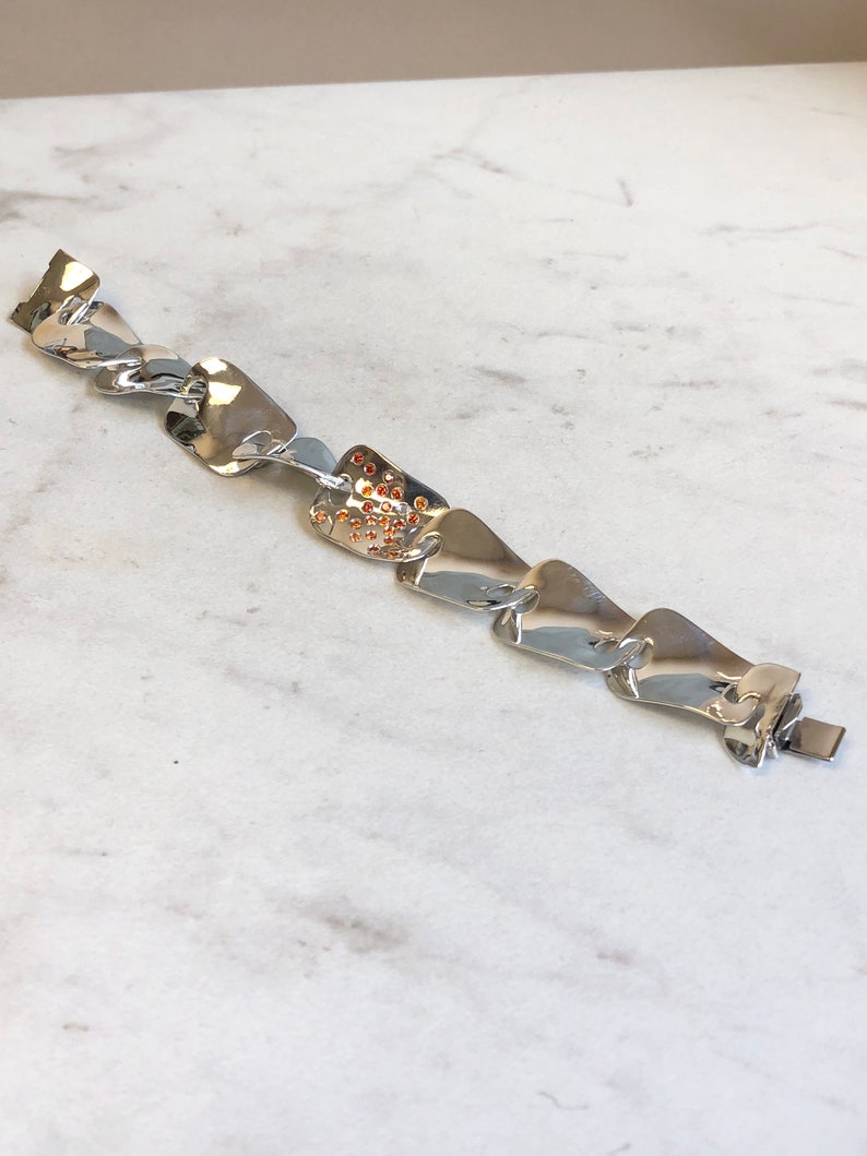 Sterling Silver Fashion Statement Bracelet with Garnet Gemstone in Center at an Incredible Price.