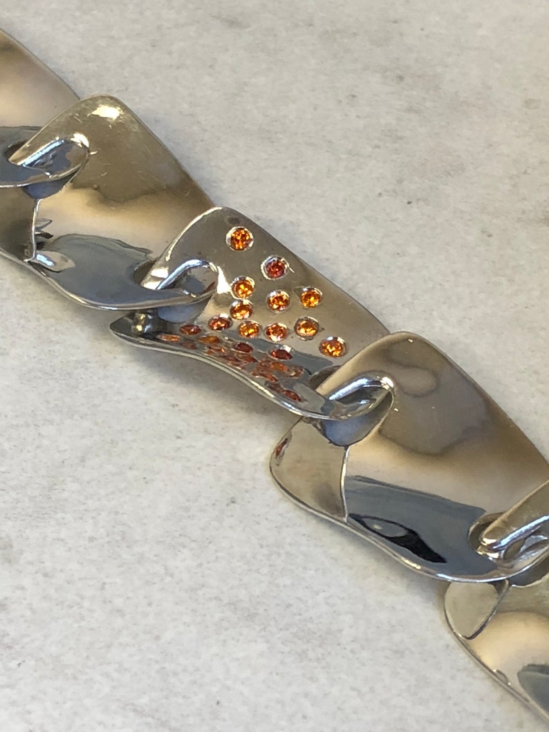 Sterling Silver Fashion Statement Bracelet with Garnet Gemstone in Center at an Incredible Price.