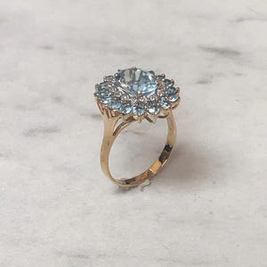 14kt Yellow Gold Lady&#39;s Cluster/Halo Diamond and Blue Topaz Fashion Statement Ring at a very affordable price.