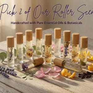 May include: Clear glass roller bottles with wooden caps, filled with essential oils and botanicals. The image includes lavender, petals, and citrus zest. Text reads "Pick 2 of Our Roller Scent" and "Handcrafted with Pure Essential Oils & Botanicals".