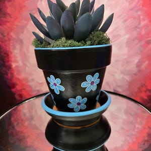 Hand-painted terracotta pot black and blue flowers with matching saucer. 4"