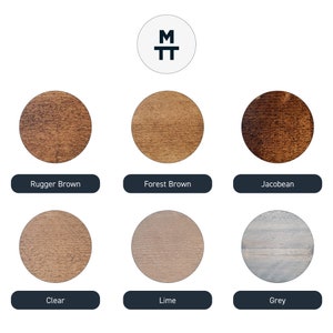 May include: A selection of six wood stain samples in circular forms. The colours are Rugger Brown, Forest Brown, Jacobean, Clear, Lime, and Grey. A logo with the letters "M" and "T" is displayed at the top.