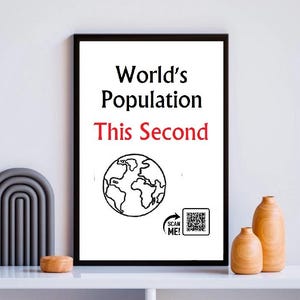 May include: A framed print with the text "World's Population This Second" above a globe illustration. A QR code with "SCAN ME!" is in the lower right. Decorative wooden vases and a grey arch-shaped object are on the shelf.