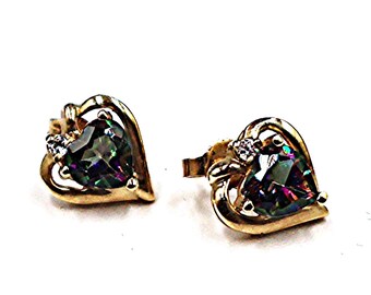 May include: A pair of gold stud earrings featuring a heart-shaped iridescent gemstone set within a gold heart-shaped frame, accented by a single small clear stone on the side of each earring, showcasing a multi-colored reflective surface.