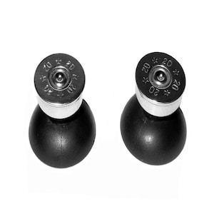 May include: Two black rubber bottle stoppers with silver tops. The tops have the number 20 printed on them.
