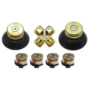 May include: Gold bullet-shaped controller buttons for a Playstation controller. The set includes four small buttons and a larger four-way directional pad.