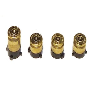 May include: Four gold-coloured bullet-shaped controller caps with black bases. The caps have the text "MODERN" and "9mm" printed on them.