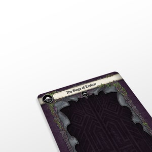May include: A game board for the The Siege of Erebor board game. The board is dark purple with a silver and black border. The board has a mountain icon in the top left corner.