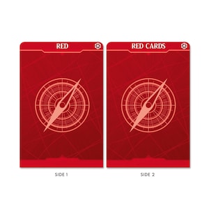 May include: Two red playing cards with a compass design. The front of the card says "RED" and the back of the card says "RED CARDS".