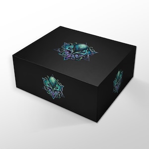 May include: A black box featuring a teal, purple, and blue octopus design. The design is repeated on the top and sides. The octopus is set within a geometric star-shaped frame. The box is a solid, matte black.