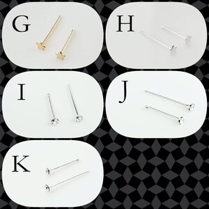 May include: Five different nose rings with various styles. The first two are gold star-shaped nose rings. The next two are silver nose rings with clear rhinestones. The last one is a silver nose ring with a clear rhinestone.
