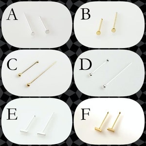 May include: Six different styles of nose rings. The nose rings are made of silver and gold. The nose rings are labelled A through F.